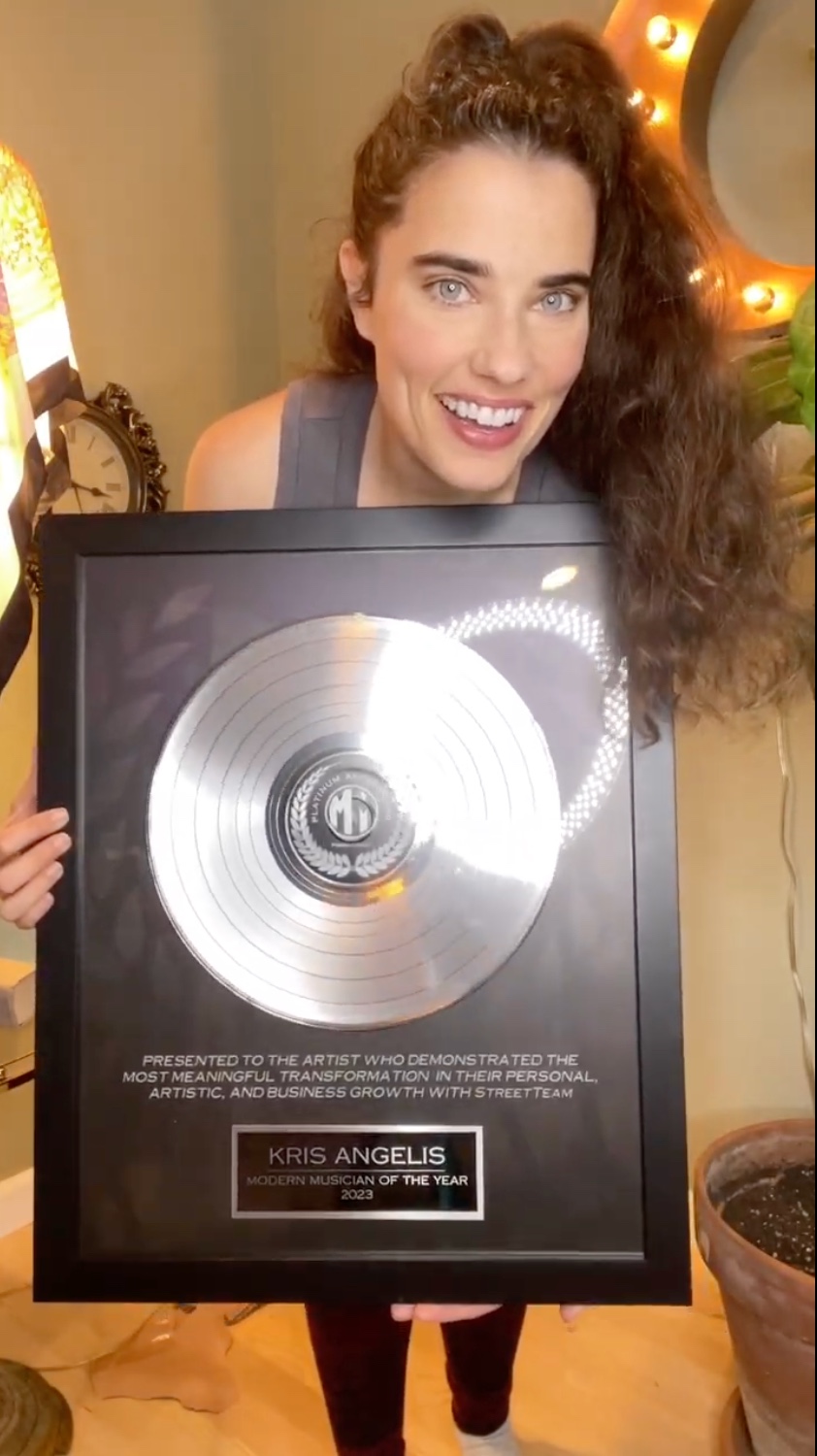 Kris Angelis receiving their Modern Musician award