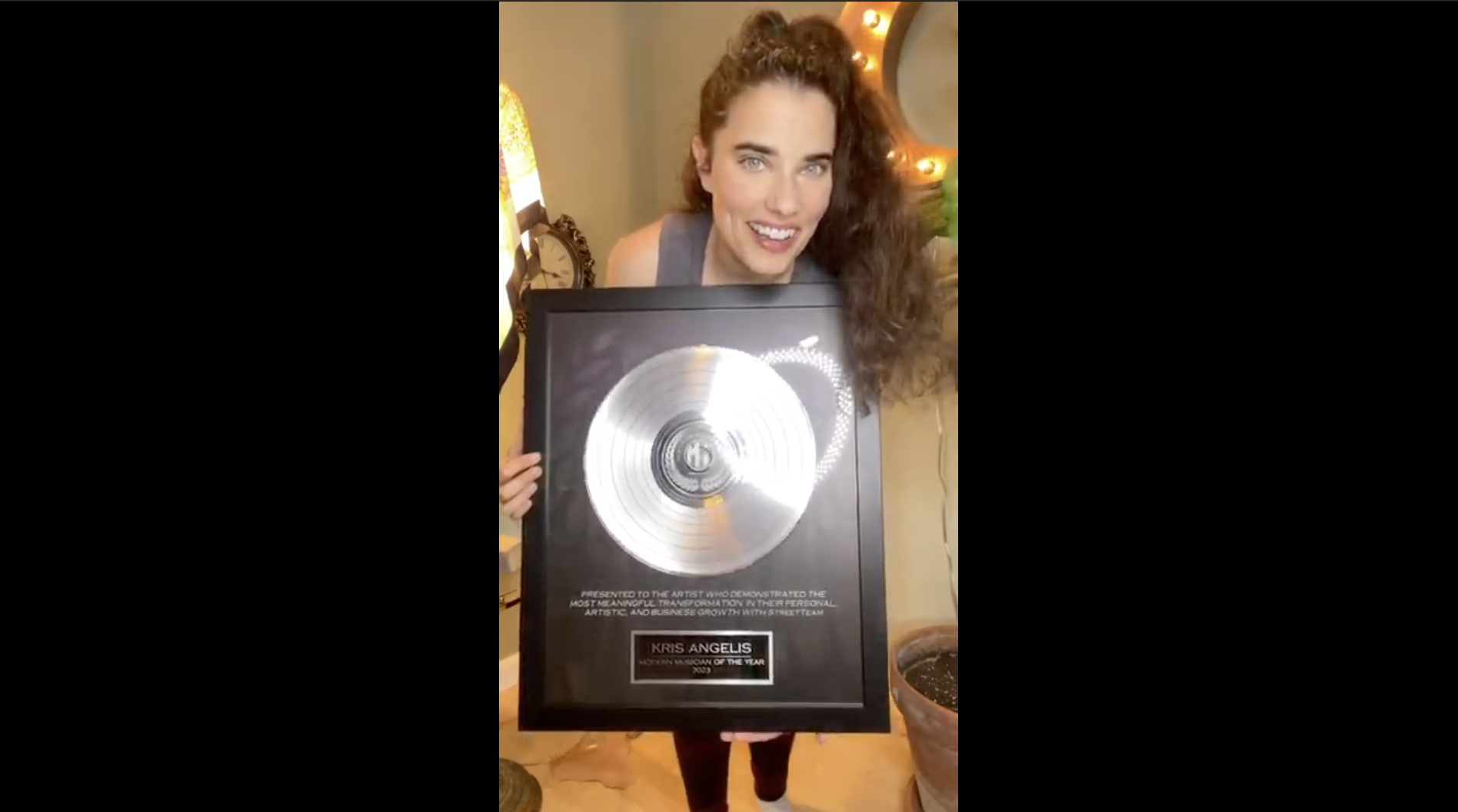Kris Angelis receiving their Modern Musician award